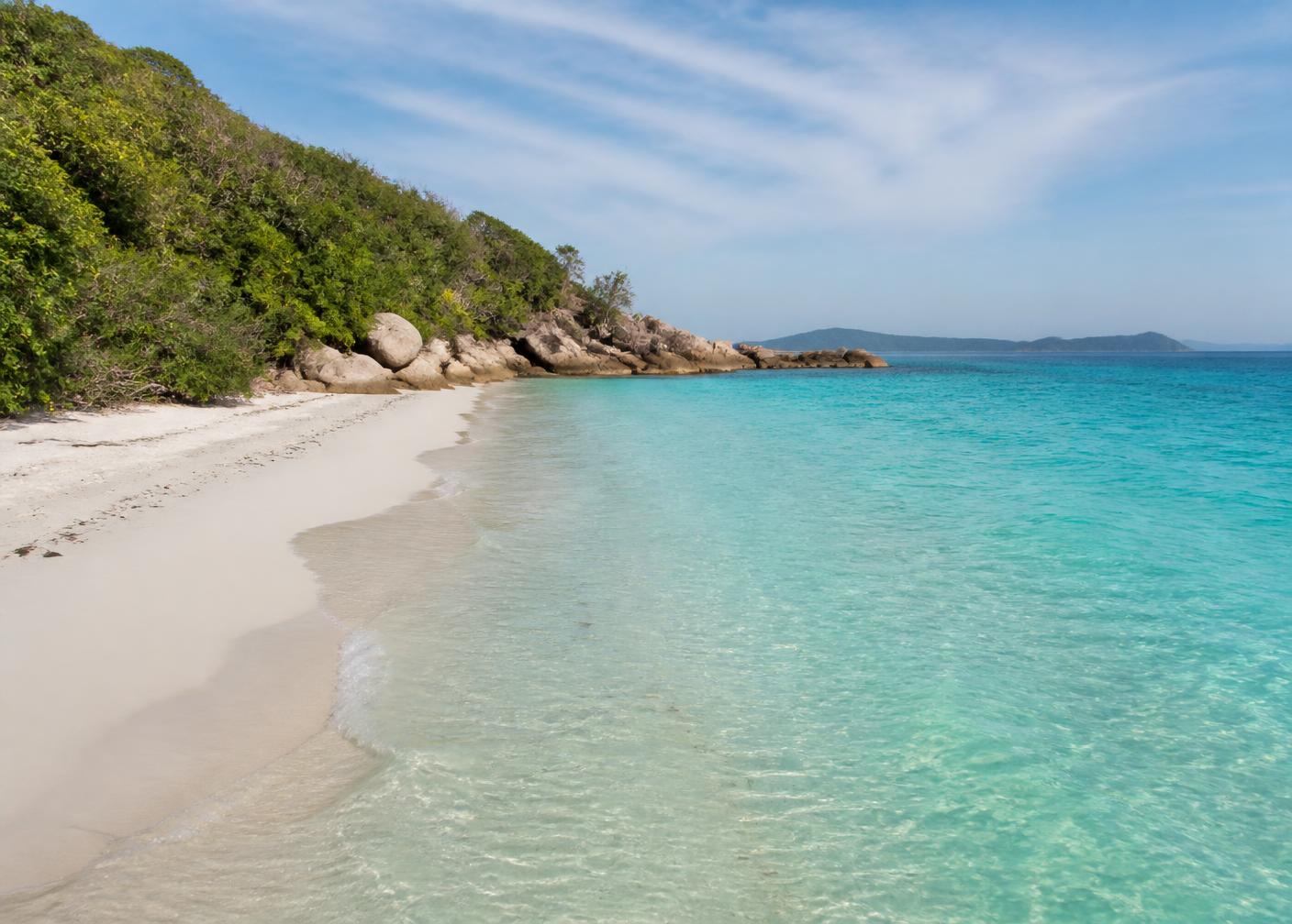Empty white sand beach with clear turquoise water